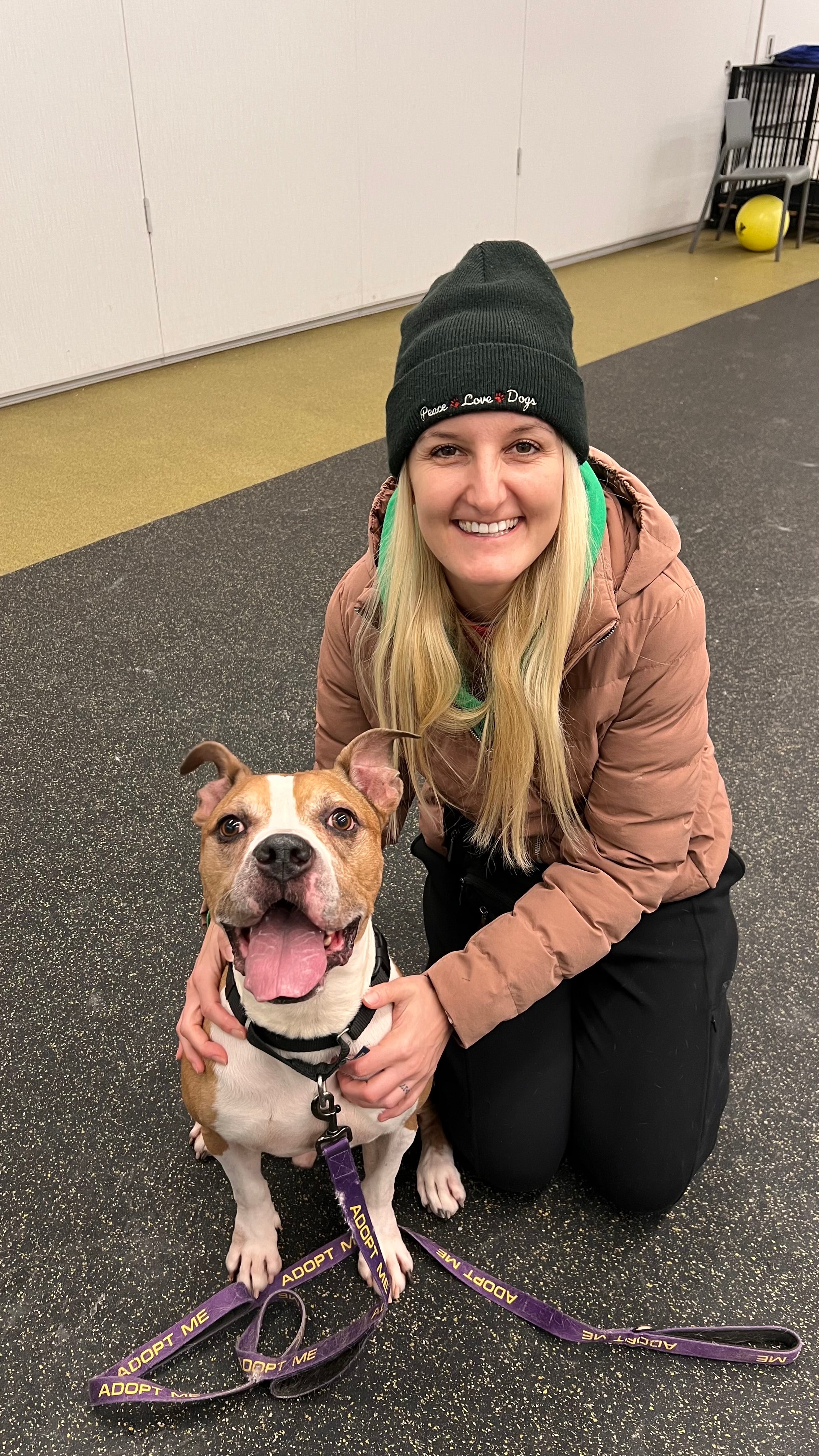 Woman with a dog on a leash indoors